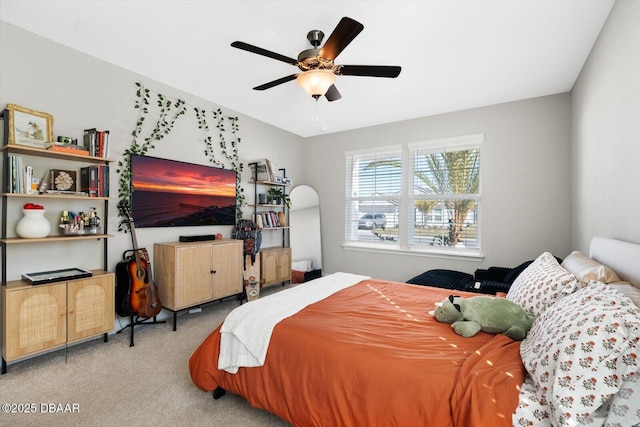 bedroom with ceiling fan and light carpet