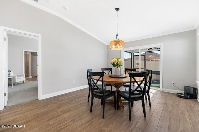 dining room with crown molding and hardwood / wood-style floors