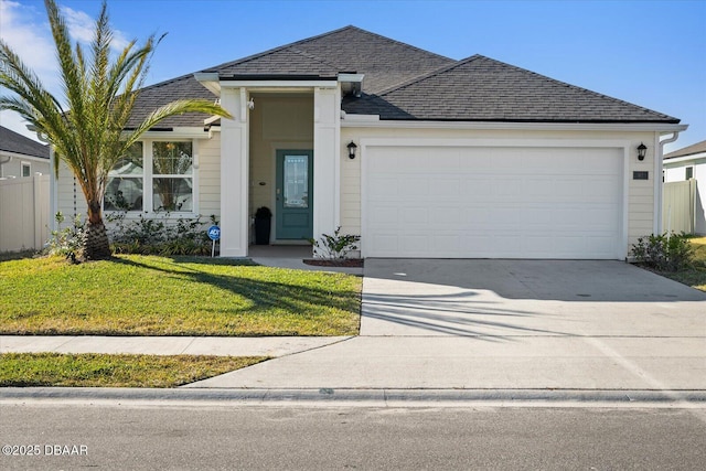 view of front of property featuring a front yard and a garage