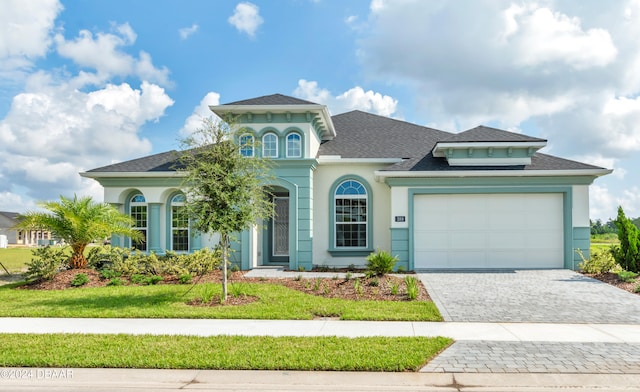 view of front of home featuring a garage and a front lawn