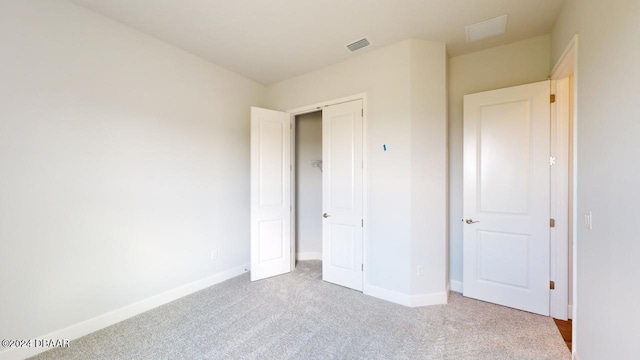 unfurnished bedroom featuring visible vents, baseboards, and carpet