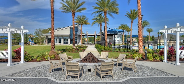 view of patio with an outdoor fire pit, a pergola, and fence