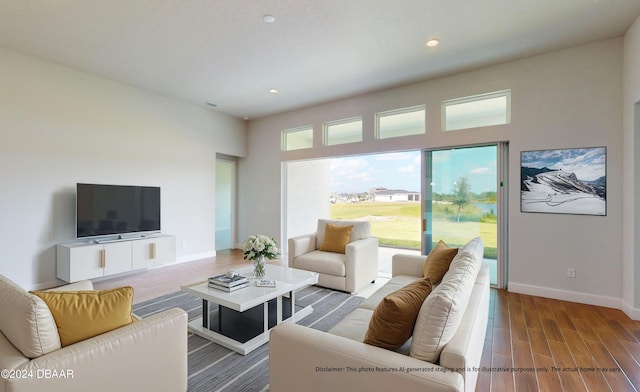 living area featuring recessed lighting, baseboards, and wood finished floors