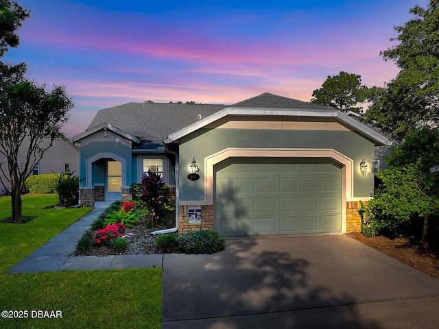 single story home with concrete driveway, stone siding, a front yard, a garage, and stucco siding