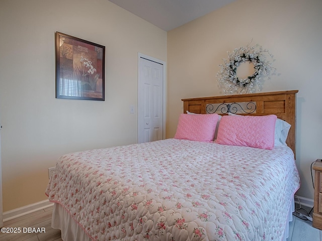 bedroom with light wood-type flooring and baseboards
