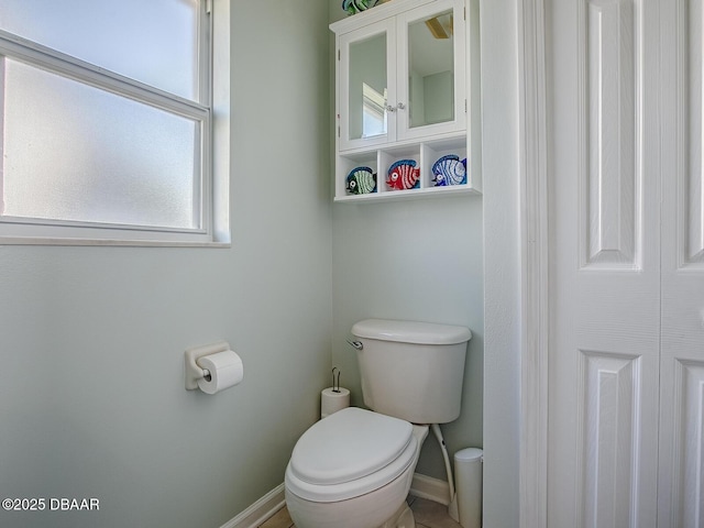 bathroom featuring toilet and baseboards