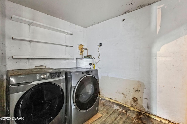 laundry area with wood-type flooring and washing machine and dryer