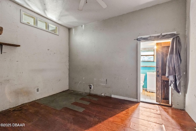 spare room with ceiling fan, a healthy amount of sunlight, and hardwood / wood-style floors