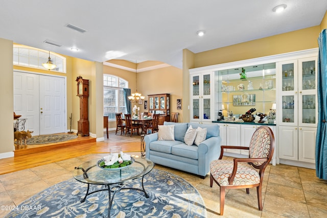 living room featuring a chandelier and light hardwood / wood-style flooring