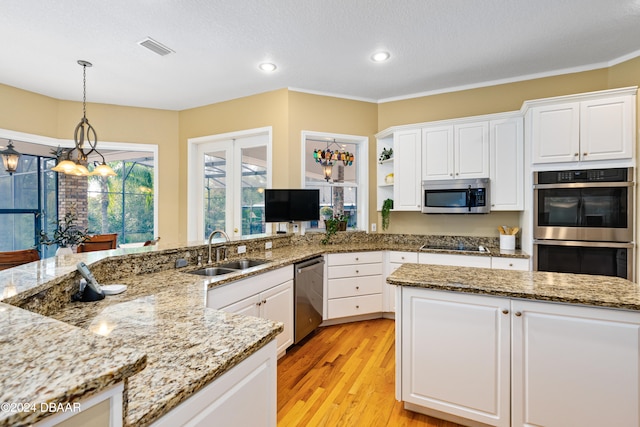 kitchen featuring white cabinetry, light hardwood / wood-style floors, appliances with stainless steel finishes, and sink