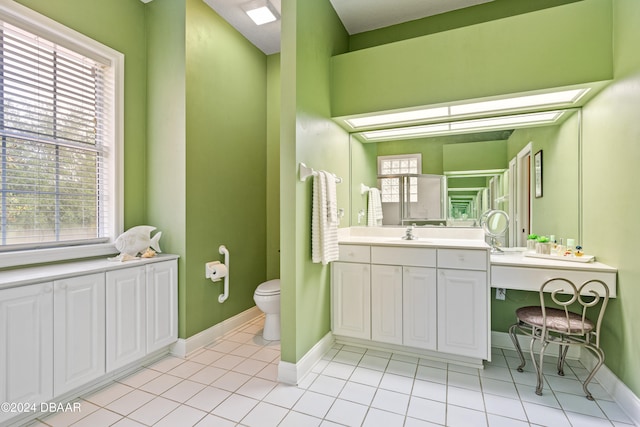 bathroom featuring vanity, tile patterned floors, and toilet