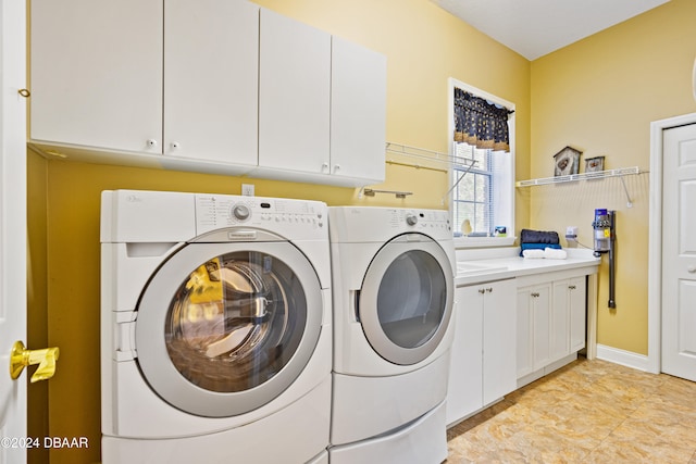 laundry area with cabinets and washer and clothes dryer