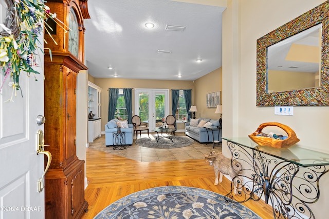 entrance foyer featuring french doors and light hardwood / wood-style floors