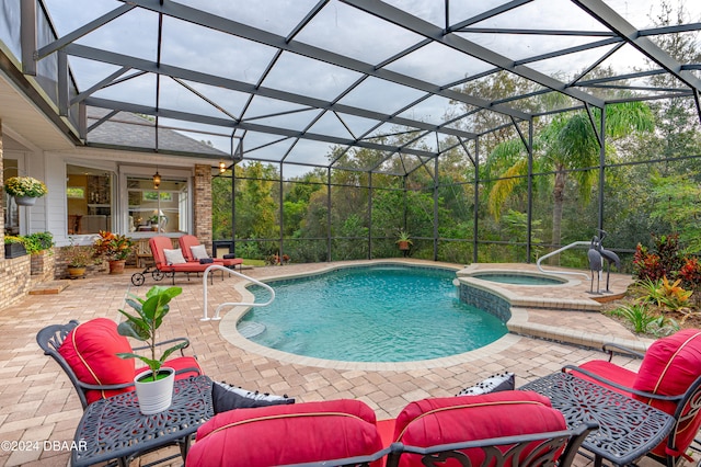 view of pool featuring a patio, a lanai, and an in ground hot tub