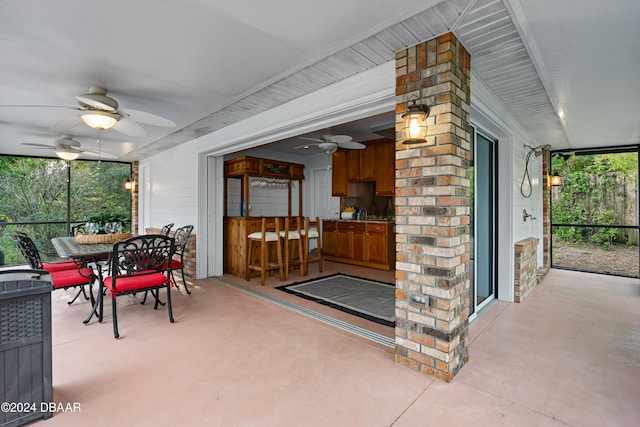 sunroom featuring ceiling fan and a healthy amount of sunlight