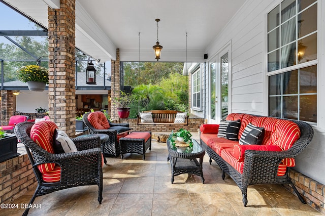 view of patio / terrace with a lanai and an outdoor living space with a fireplace