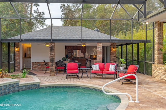 view of swimming pool featuring a lanai, outdoor lounge area, and a patio area