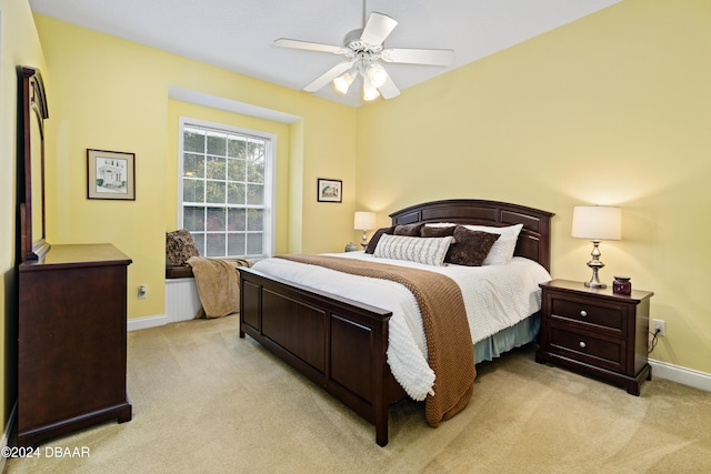 bedroom featuring ceiling fan and light carpet