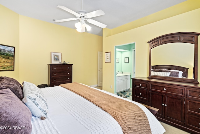 bedroom featuring ceiling fan, connected bathroom, and light carpet