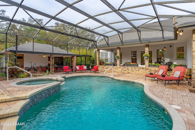 view of swimming pool with a patio area, a lanai, and an in ground hot tub