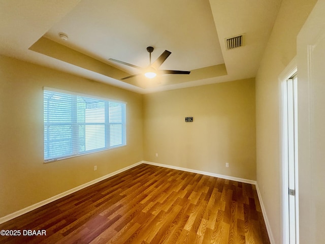 306 Coral Reef Way, Daytona Beach, FL 32124 - empty room featuring a raised ceiling, wood finished floors, a ceiling fan, and a smoke detector