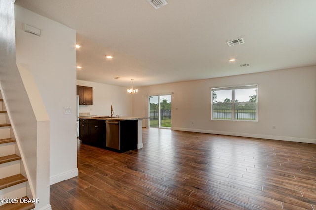569 Armoyan Way, New Smyrna Beach, FL 32168 - kitchen with dishwasher, a chandelier, open floor plan, dark wood finished floors, and an island with sink