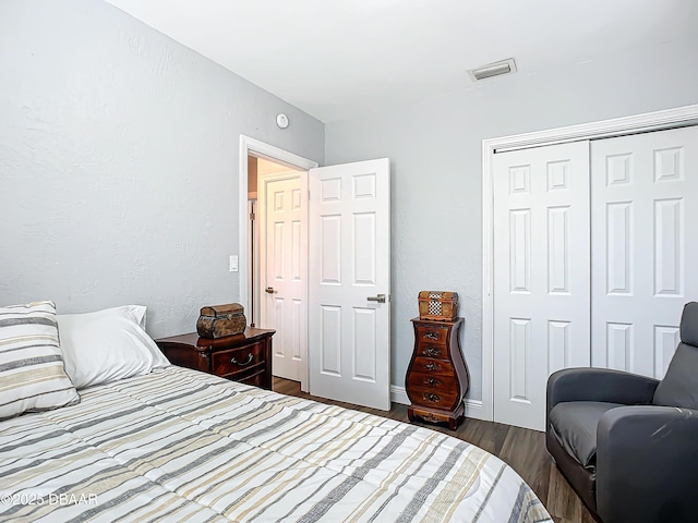 bedroom with a closet and dark wood-type flooring