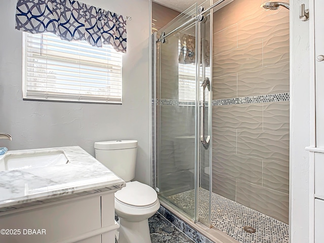 bathroom with vanity, an enclosed shower, and toilet