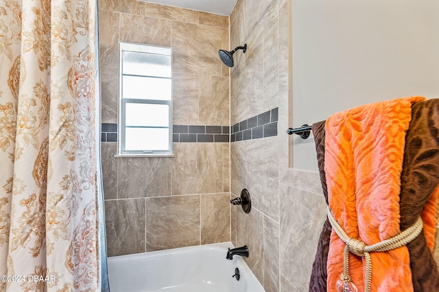 bathroom with shower / bath combo with shower curtain