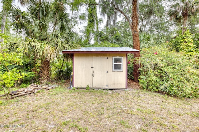 view of outbuilding featuring a yard