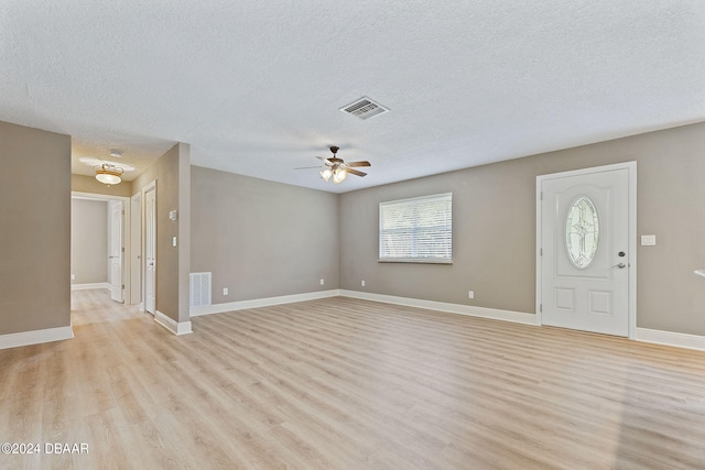 entrance foyer with light wood-type flooring, a textured ceiling, and ceiling fan