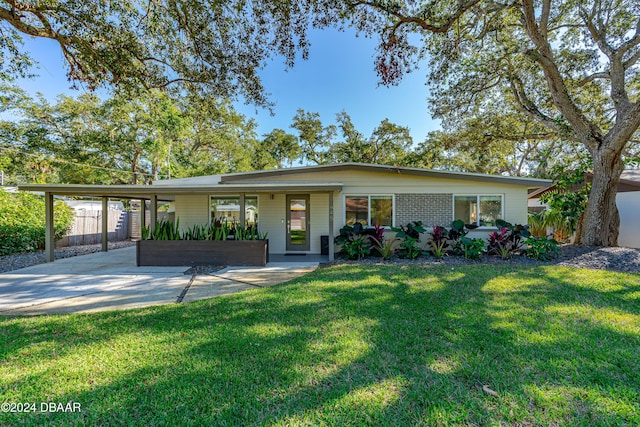 single story home with a front yard and a carport