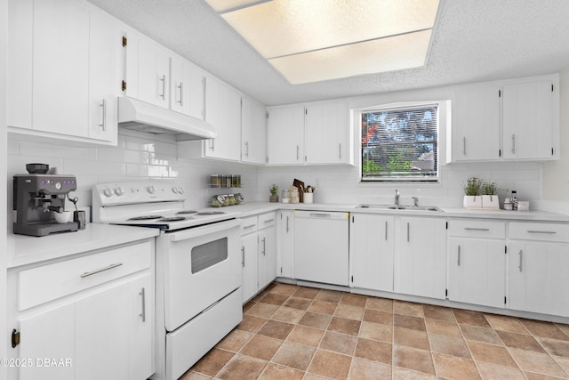 kitchen featuring tasteful backsplash, white cabinetry, sink, and white appliances