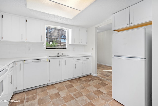 kitchen featuring white cabinetry, white appliances, sink, and tasteful backsplash