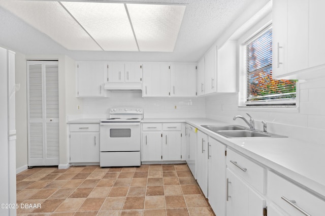 kitchen featuring sink, white cabinets, backsplash, and electric stove