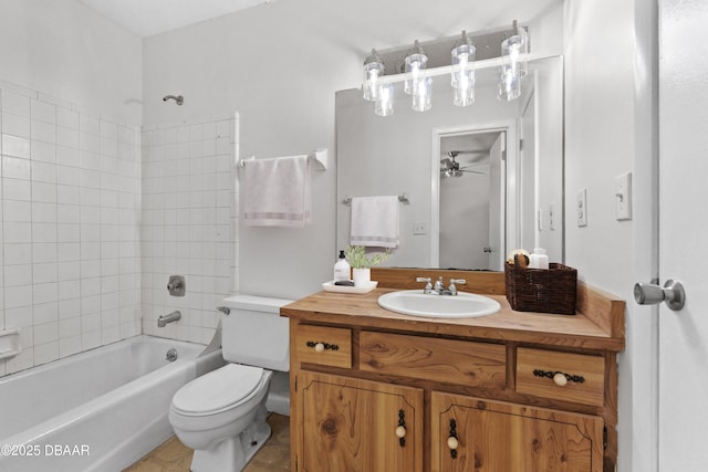 full bathroom with ceiling fan, vanity, toilet, and tiled shower / bath combo