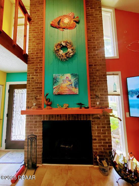 interior details featuring a brick fireplace