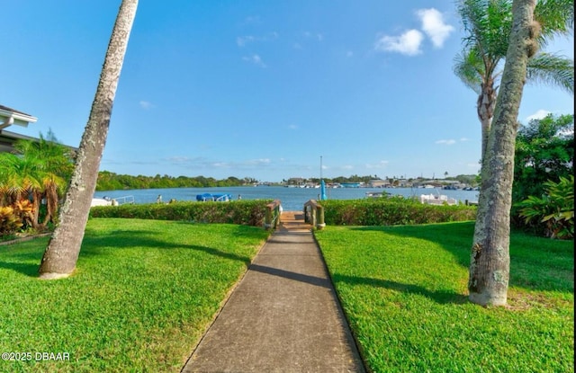 view of home's community featuring a water view and a yard