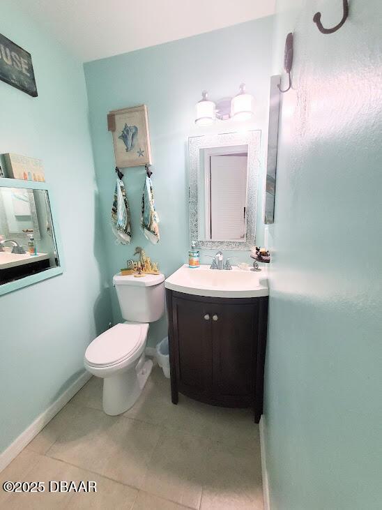 bathroom with vanity, tile patterned floors, and toilet