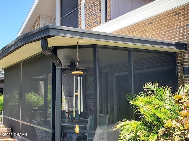 view of home's exterior with a sunroom