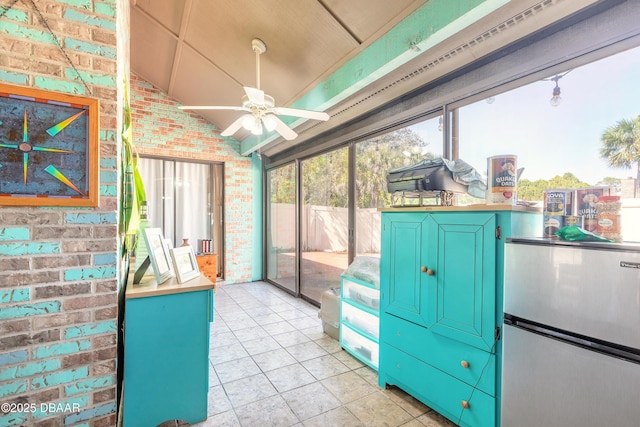 sunroom / solarium with a ceiling fan and vaulted ceiling