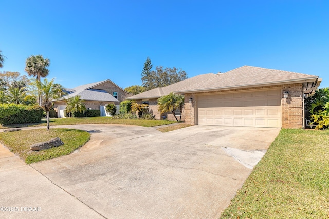 view of front of house featuring brick siding, driveway, an attached garage, and a front yard