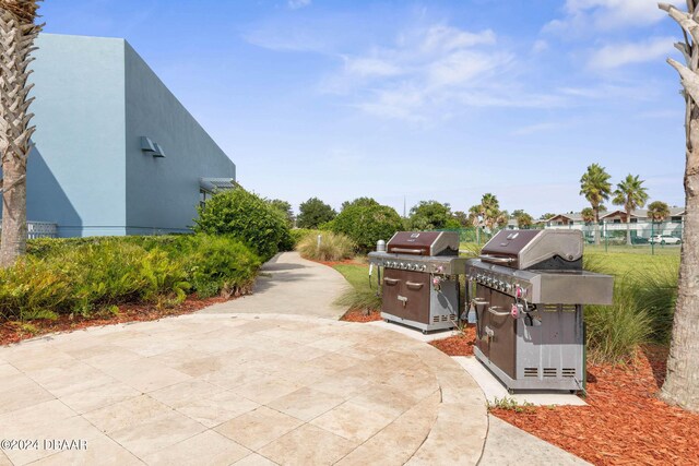 241 Riverside Dr Unit 1401-2, Holly Hill, FL 32117 - view of patio / terrace with area for grilling and fence