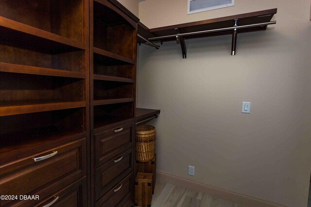 spacious closet with light hardwood / wood-style floors