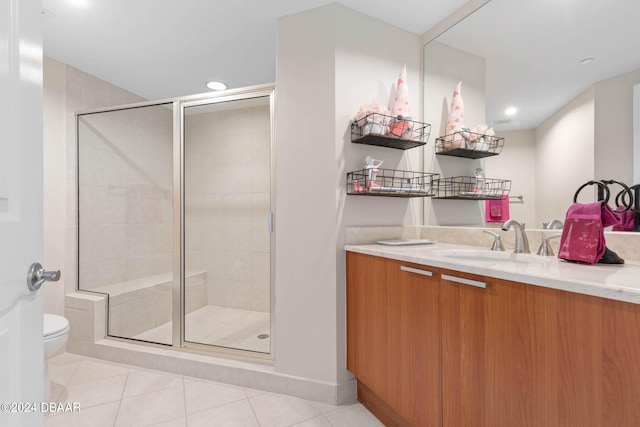 bathroom with toilet, vanity, tile patterned floors, and walk in shower