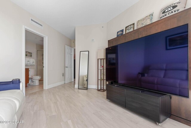 241 Riverside Dr Unit 1401-2, Holly Hill, FL 32117 - living room with baseboards, light wood-style flooring, and a towering ceiling