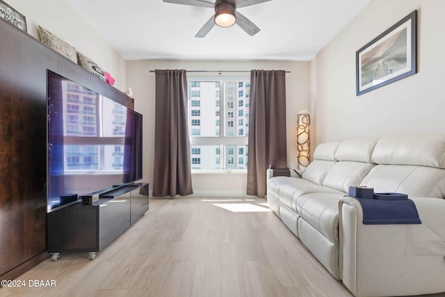 living room featuring ceiling fan and light hardwood / wood-style flooring