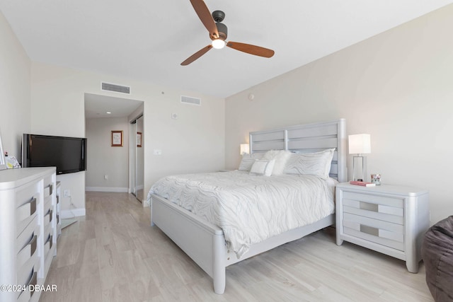 bedroom with light hardwood / wood-style floors and ceiling fan