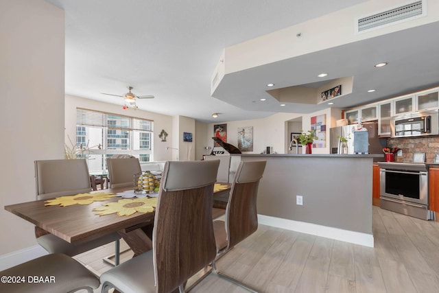 241 Riverside Dr Unit 1401-2, Holly Hill, FL 32117 - dining room featuring light wood-style flooring, baseboards, ceiling fan, and recessed lighting