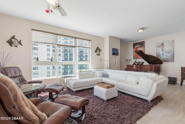 living room with ceiling fan and light hardwood / wood-style floors